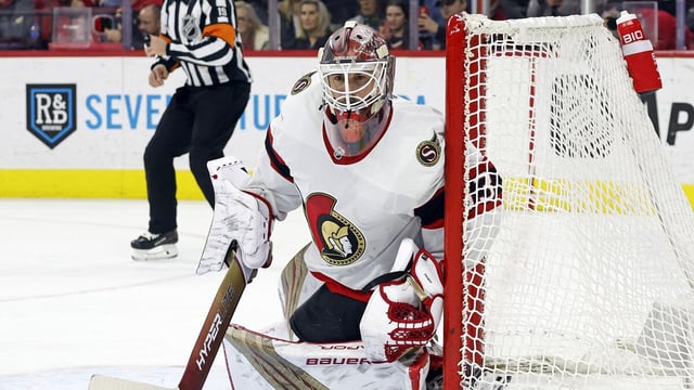 Ottawa Senators goaltender Cam Talbot squats and watches the puck move during a game