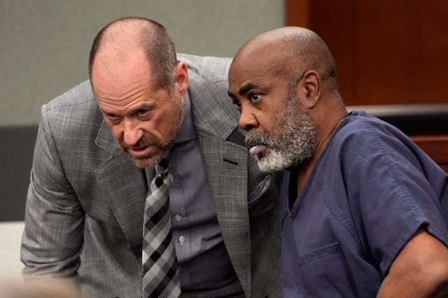 Duane “Keffe D” Davis speaking with his attorney Ross Goodman in court.