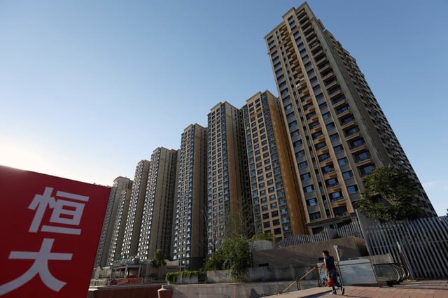 A China Evergrande sign is seen near residential buildings at a residential complex in Beijing on September 27, 2023. Photo: Reuters