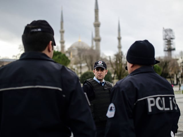 TOPSHOT - Turkish police officers stand guard near the Blue Mosque in Istanbul's tourist hub of Sultanahmet on January 13, 2016, a day after an attack. Turkish authorities probed how a jihadist from Syria killed 10 mainly German tourists in an attack in the heart of Istanbul that raised alarm over security in the city. (Photo by BULENT KILIC / AFP) (Photo by BULENT KILIC/AFP via Getty Images)