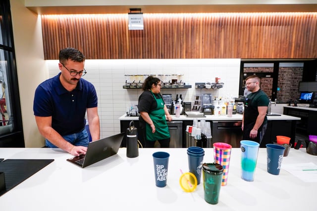 Implementation specialist Chris Miller works during a reusable personal cup test at the Tryer Center at Starbucks headquarters in Seattle on June 28, 2023.