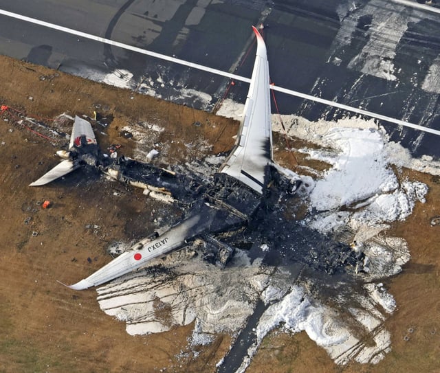 The burnt Japan Airlines plane at Haneda airport in Tokyo. Photo: Kyodo via Reuters