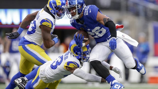 New York Giants running back Saquon Barkley (26) runs the ball against Los Angeles Rams safety John Johnson III (43) during the second half an NFL football game, Sunday, Dec. 31, 2023, in East Rutherford, N.J. (AP Photo/Adam Hunger)