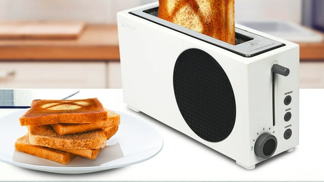 The Xbox Series S Toaster 2 Slice Toaster on a kitchen counter making toast.