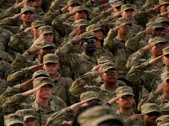 Members of the U.S. Military salute during a ceremony to redesignate Fort Benning as Fort Moore, at Doughboy Stadium in Columbus, Georgia, on May 11, 2023. Calls to rename nine military bases, all of which are located in southern states that seceded and briefly formed the Confederacy, gained momentum during nationwide protests against racism and police brutality that were sparked by the 2020 murder of George Floyd, an African American man who died at the hands of a white police officer in Minneapolis. (Photo by CHENEY ORR / AFP) (Photo by CHENEY ORR/AFP via Getty Images)