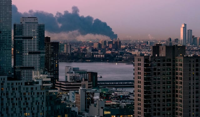 A warehouse burns spreading smoke over the southern skyline of New York in Elizabeth, N.J., on Jan. 5, 2024.
