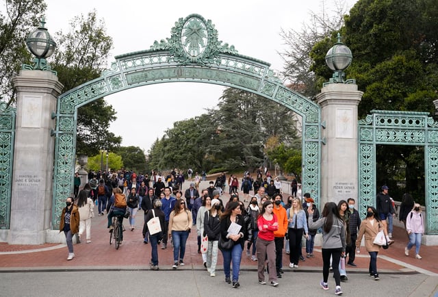Students make their way through the Sather Gate near Sproul Plaza on the University of California, Berkeley, campus on March 29, 2022.