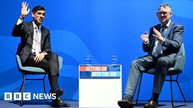 Britain's Chancellor of the Exchequer Rishi Sunak (L) speaks in conversation with MP Paul Maynard during the Conservative Party Spring Conference, at Blackpool Winter Gardens in Blackpool, north-west England on March 18, 2022.