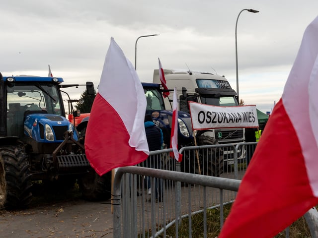 Polish flags are seen as farmers stand on a strike post as they block truck transport in Medyka - another border crossing between Poland and Ukraine, on November 23, 2023. The farmers joined the transport sector in the strike against poor management of agricultural imports of Ukrainian produce as well as demand renegotiation of transport deals between Ukraine and the European Union. Medyka is the fourth strike site. Protesters already blocked 3 other crossings for truck transport, allowing only 4 trucks per an hour excluding humanitarian and military aid and sensitive chemical and food goods. According to the drivers, the queue to the Medyka crossing was nearly 7 days even before the strike started today. (Photo by Dominika Zarzycka/NurPhoto via Getty Images)
