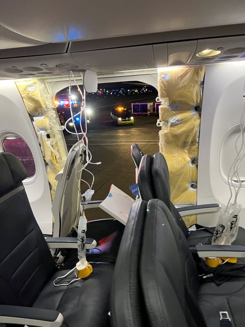 Oxygen masks hang from the roof next to a missing window and a portion of a side wall of an Alaska Airlines Flight 1282. Photo: Instagram/@strawberrvy via Reuters
