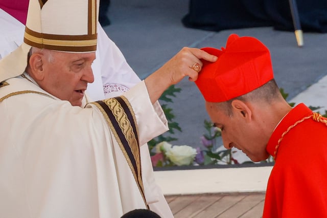 Cardinal Víctor Manuel Fernández, Prefect of the Dicastery for the Doctrine of the Faith, right, receives his biretta from Pope Francis as he is elevated in St. Peter’s Square at The Vatican on September 30, 2023. Photo: AP