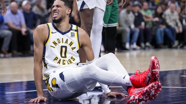 Indiana Pacers guard Tyrese Haliburton (0) reacts after being injured during the first half of an NBA basketball game against the Boston Celtics in Indianapolis, Monday, Jan. 8, 2024. (AP Photo/Michael Conroy)