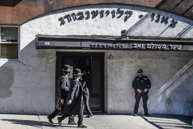 NEW YORK, NEW YORK - OCTOBER 13: A member of the New York Police Department patrols in front of a synagogue on October 13, 2023 in the Williamsburg neighborhood in the borough of Brooklyn in New York City. Security has increased in New York City in the wake of the Hamas attack on Israel and after a former leader of Hamas called for Friday the 13th to be a global Jihad day. (Photo by Stephanie Keith/Getty Images)