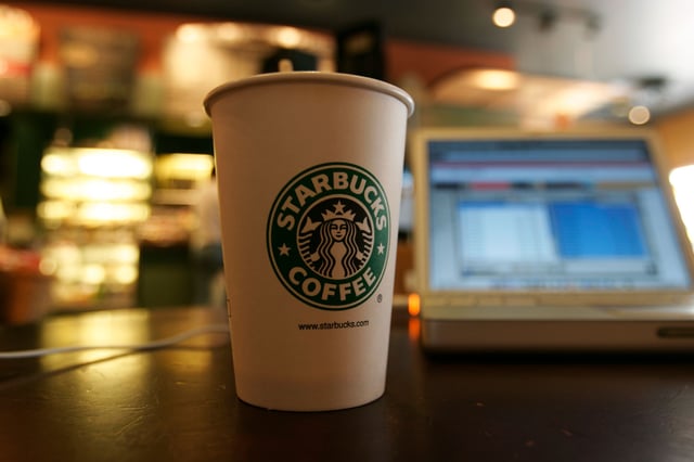 A coffee cup sits next to a laptop connected to the Internet using a Wi-Fi modem at a Starbucks coffee house. Starbucks, in conjunction with the cellular phone company T-Mobile, has started offering wireless Internet access at many of their stores.