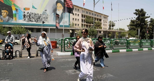 Women walk on the streets of Tehran as Iran’s “morality police” resume hijab patrols, July 18, 2023.