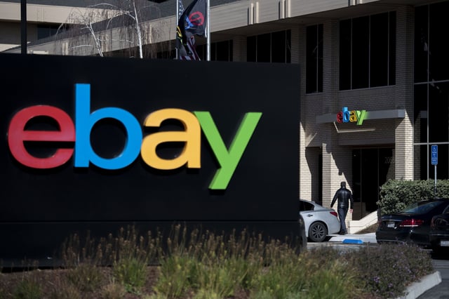 A pedestrian walks past eBay Inc. signage at the entrance to the company's headquarters in San Jose, California, U.S., on Tuesday, Jan. 24, 2017.