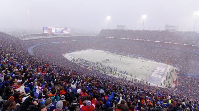 Fans cheer as snow falls during the first half in the AFC Divisional Playoff game between the Cincinnati Bengals and the Buffalo Bills at Highmark Stadium on January 22, 2023 in Orchard Park, New York.
