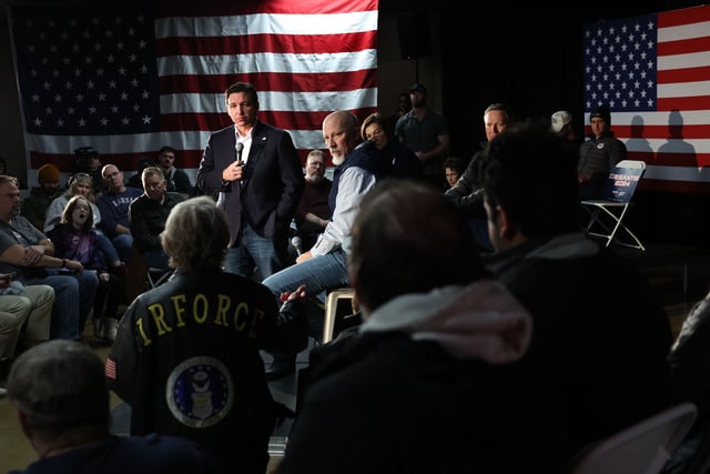 Florida Gov. Ron DeSantis (L) takes a question from an audience member at a campaign event at The Grass Wagon on January 13, 2024 in Council Bluffs, Iowa.