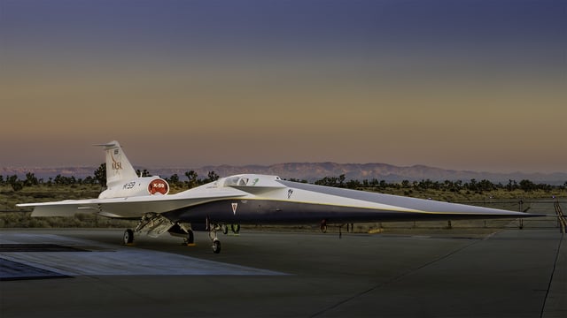 NASA’s X-59 quiet supersonic research aircraft sits on the apron outside Lockheed Martin’s Skunk Works facility at dawn in Palmdale, California. The X-59 is the centerpiece of NASA’s Quesst mission, which seeks to address one of the primary challenges to supersonic flight over land by making sonic booms quieter. Lockheed Martin Skunk Works