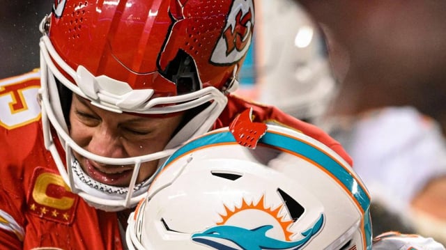 The helmet of Kansas City Chiefs quarterback Patrick Mahomes (15) breaks while being hit by Miami Dolphins safety DeShon Elliott (21) on a run in the third quarter Saturday, Jan. 13, 2024, at GEHA Field at Arrowhead Stadium.
