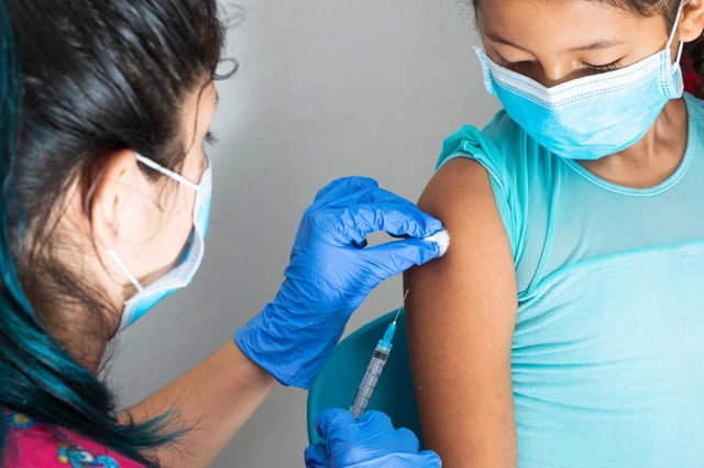 Children's nurse wiping blood with cotton wool