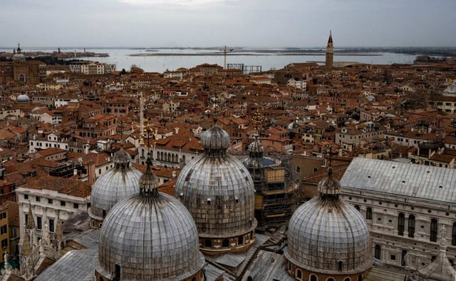 St. Mark’s Basilica (front) seen from St Mark’s Campanile (bell tower) and a view of Venice towards the east. Photo: AFP