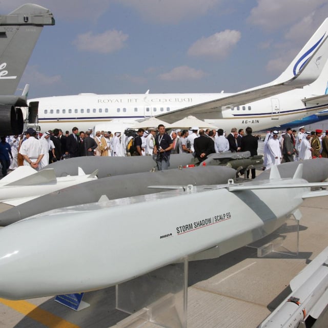 Visitors pass behind the French made Storm Shadow/SCALP EG cruise missiles at the opening of the five-day Dubai Air Show in Dubai 20 November 2005. France has committed to sending new SCALP cruise missiles and hundreds of bombs to Ukraine, ramping up the pressure on Berlin to pledge the long-range Taurus missiles Ukraine has long asked for but failed to receive in aid packages from Germany.