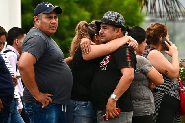 Relatives of slain prosecutor Cesar Suarez outside the morgue in Guayaquil, Ecuador on January 17.