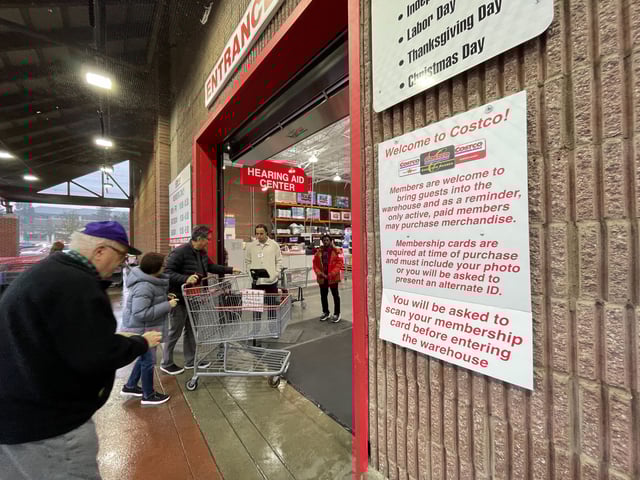 Costco customers entering a store in Issaquah, Wash., have their membership cards scanned on Wednesday. (GeekWire Photo / Taylor Soper)