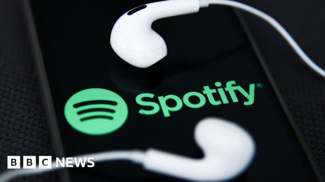 Spotify logo with iPhone headphones