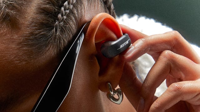 A user wearing the Kith for Bose Ultra Open Earbuds.