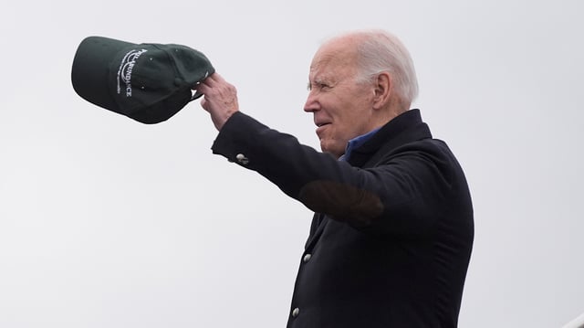 President Joe Biden arrives at the Philadelphia International Airport, Monday, Jan. 15, 2024, in Philadelphia, holding a Philabundance hat, a hunger relief organization in Philadelphia, where he plans to volunteer for the third year in a row in observance of the Martin Luther King, Jr., Day of Service. (AP Photo/Evan Vucci)