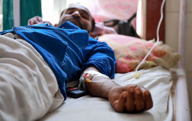 An Indian patient lies on a bed at a government hospital after suffering heat stroke, in Churu, Rajasthan on June 4, 2019.