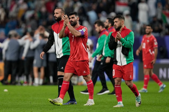 Palestine’s players thank supporters for their loud and incessant backing during the draw with UAE. Photo: AP