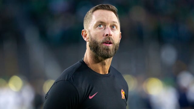 Kliff Kingsbury of USC looks at the Jumbotron during pregame warmups before a game between University of Southern California and University of Notre Dame at Notre Dame Stadium on October 14, 2023 in South Bend, Indiana.