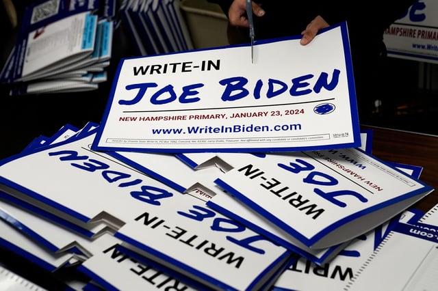 As part of a school internship, a political science student from St. Olaf College in Minnesota assembles a sign promoting the write-in campaign to put U.S. President Joe Biden's name on the New Hampshire Democratic primary ballot, at the New Hampshire AFL-CIO office in Hooksett, New Hampshire, U.S., January 15, 2024.