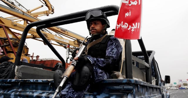 A Yemeni security soldier loyal to the Houthi movement guards a truck during a protest held to condemn the U.S. for redesignating Houthis as a global terrorist group, and against the U.S.-British aerial attacks conducted on Yemen on Friday in Sana'a, Yemen. (Mohammed Hamoud / Getty Images)
