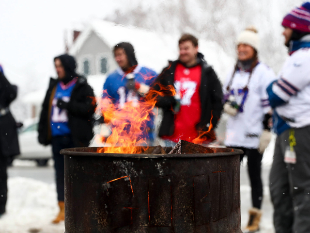 ORCHARD PARK, NY - DECEMBER 17: Buffalo Bills fans tailgate behind a fire prior to an NFL football game between the Miami Dolphins and the Buffalo Bills on December 17, 2022 in Orchard Park, New York. (Photo by Kevin Sabitus/Getty Images)
