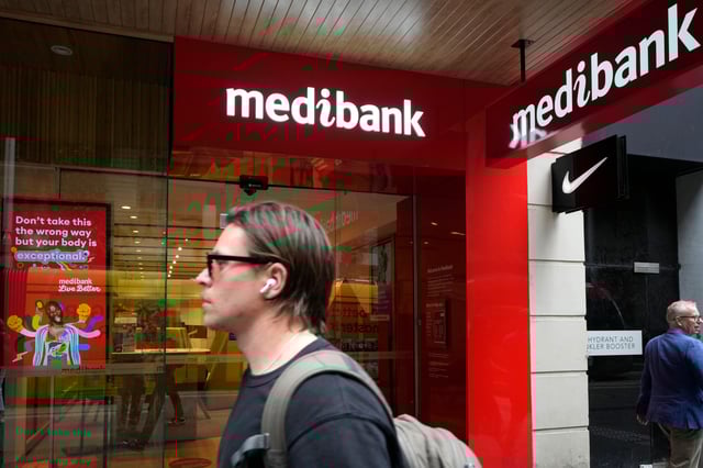 A man walks past a Medibank branch in Sydney on Oct. 26, 2022. A Russian national has been sanctioned on Tuesday, Jan. 23, 2024, by the Australian government for his role in a cyber attack which compromised the personal details of more than 10 million Australians. (AP Photo/Rick Rycroft, File)