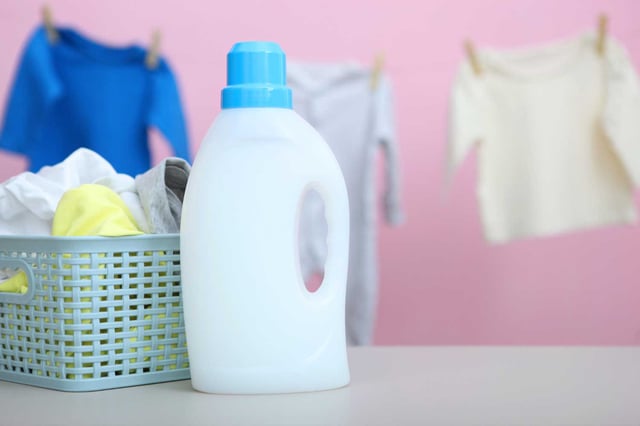 Photo baby clothes and detergents on the table baby