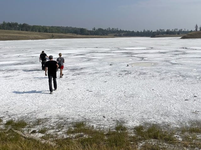 Researchers walk across Last Chance Lake’s crusty surface in September 2022. (UW Photo / Zack Cohen)
