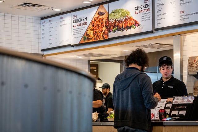 A customer pays for their food at a Chipotle Mexican Grill restaurant