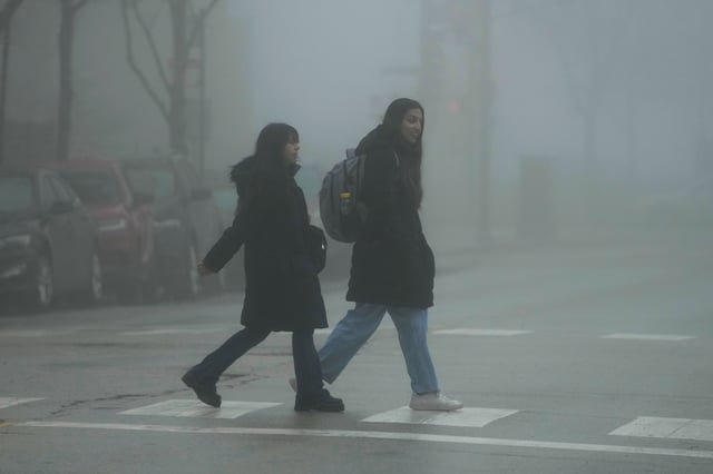 Pedestrians cross a street in the fog on Thursday, Jan. 25, 2024., in Chicago.