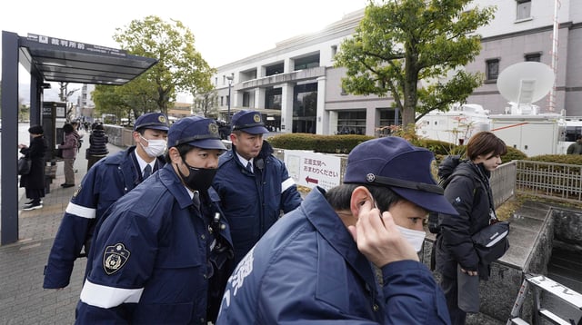 Police officers gather outside the Kyoto District Court in Kyoto, western Japan, Thursday, Jan. 25, 2024, ahead of the sentencing hearing for Shinji Aoba, who has confessed to a deadly arson attack in July 2019 on a Kyoto Animation Co. studio.