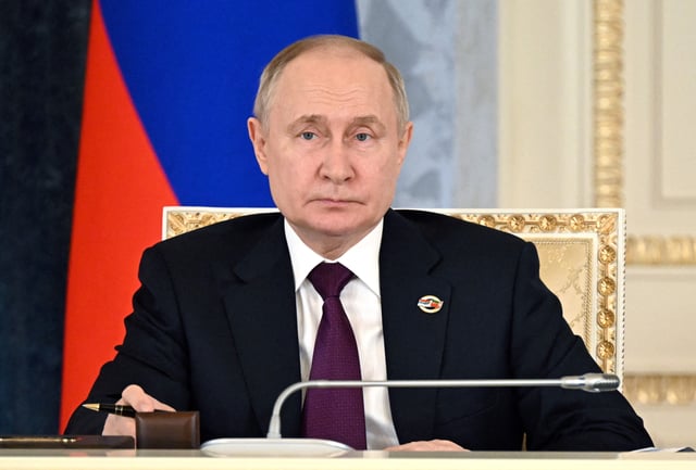 Vladimir Putin attends a meeting