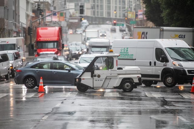 FILE - Traffic is diverted from Fremont Street onto Howard Street due to high winds and windows breaking and crashing to the street around the Transbay Terminal during a rainstorm in San Francisco on March 28, 2023.