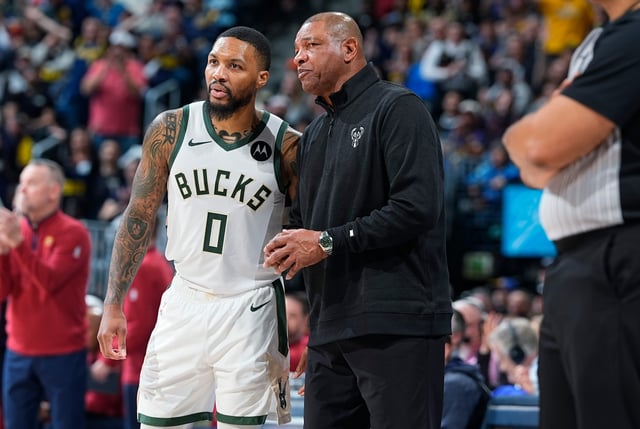 Bucks guard Damian Lillard confers with new head coach Doc Rivers late in their game against the Nuggets on Monday night in Denver.