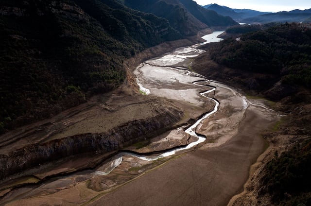 View of La Baells reservoir, which is only at 21 percent of its capacity, near Berga, north of Barcelona, Spain, Tuesday, Jan. 23, 2024. Barcelona and the surrounding area of Spain's northeast Catalonia are preparing to face tighter water restrictions amid a historic drought that has shrunk reservoirs to record lows. Catalonia has recorded below-average rainfall for 40 consecutive months. Experts say that the drought is driven by climate change and that the entire Mediterranean region is forecast to heat up at a faster rate than many other regions in the coming years. (AP Photo/Emilio Morenatti)