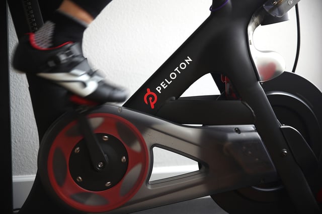 A person rides her Peloton exercise bike at her home on April 06, 2020 in San Anselmo, California.