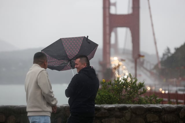 FILE - Winds turned umbrella inside out at viewing point in Marin Calif., Jan. 31, 2024